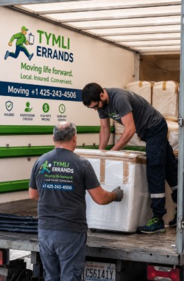 Movers in Newcastle WA loading furniture into moving truck for local home relocation