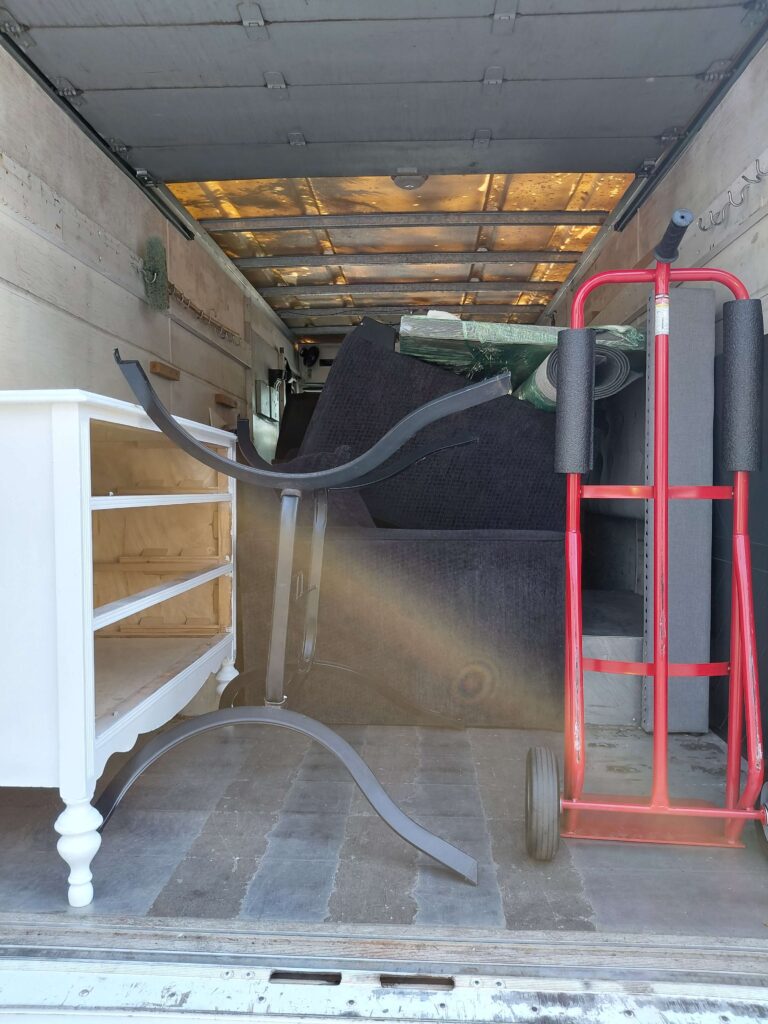 Movers loading furniture for a condo move from Des Moines to Federal Way, WA