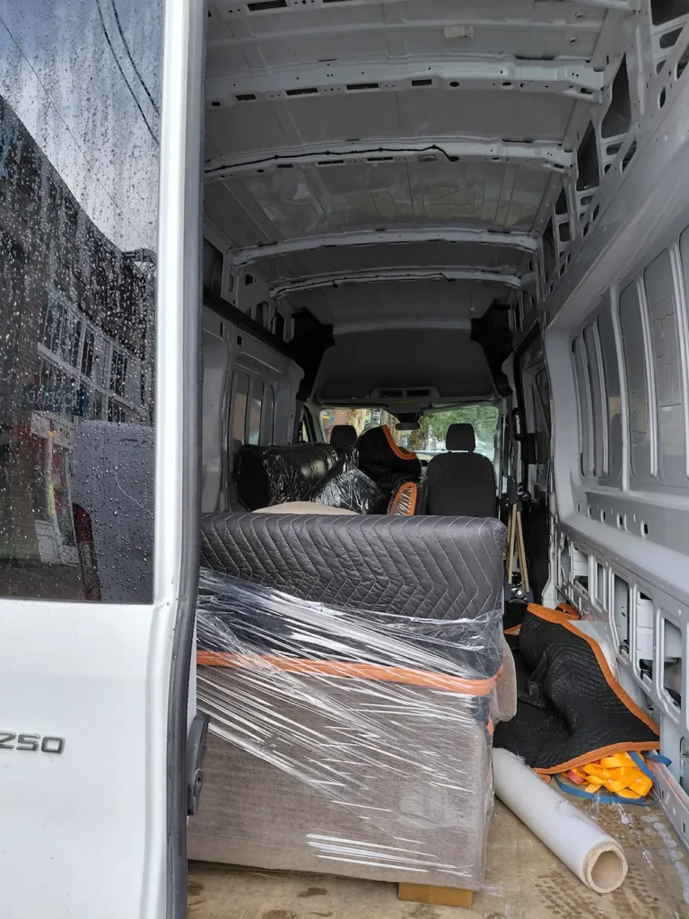 TYMLI truck loaded with wrapped furniture during a small move on Pike Street Seattle.