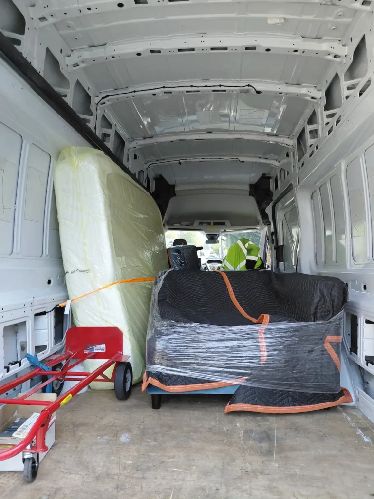 Furniture wrapped and secured inside TYMLI cargo van during a Tacoma move