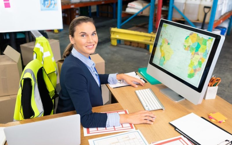 female-manager-working-computer-desk-warehouse_13339-357731